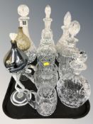 A group of crystal decanters including a Thomas Webb example, two glass oil lamps, etc.