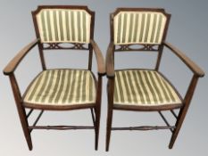 A pair of reproduction mahogany armchairs in striped upholstery.