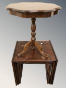 An Italian style pedestal occasional table and a stained teak nest of three tables.