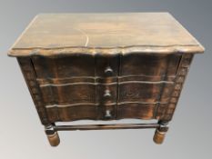 A carved beech serpentine front three drawer chest, 65 cm x 36 cm x 60 cm.