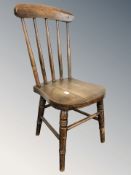 A child's elm windsor armchair, height 71 cm, and a further child's spindle back chair.
