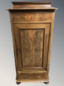 A 19th century Continental walnut sentry door cabinet,