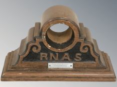 A carved wooden clock case made from wreckage of HMS Bulwark, width 29 cm.