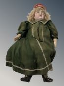 A porcelain headed doll, stamped 'Made in Germany, 13 129', height 53 cm.
