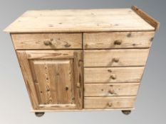 A pine side cabinet fitted cupboard and drawers, 90 cm W x 45 cm D x 84 cm H.