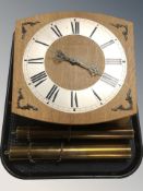A Junghans oak wall clock with silvered dial, brass weights and pendulum.
