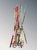 A group of fishing rods and reels.