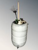A water butt and a group of garden tools
