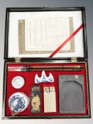 A Chinese caligraphy set in lacquered case