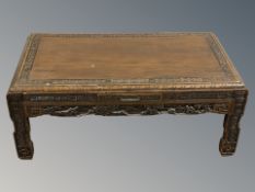 An oriental carved camphor wood low table, width 90 cm.
