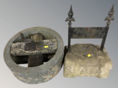 A concrete and painted metal boot scraper,