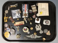 A group of reproduction military medals, decorations, various lapel badges, etc.