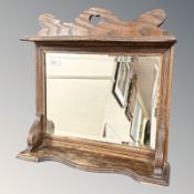 An Arts and Crafts oak bevelled mirror, 49 cm x 48 cm.