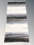 A flatweave kilim, 143 cm x 66 cm.