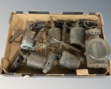 A group of antique blow torches and a lantern.