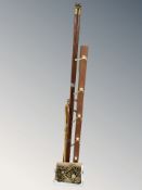 A group of walking sticks, teak and brass coat rack, brass hangers, etc.