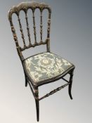 A 19th century ebonised and gilt occasional chair.