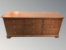 A reproduction nine drawer low chest, 156 cm x 46 cm x 69 cm.