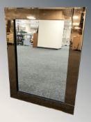 An Art Deco style peach glass mirror,