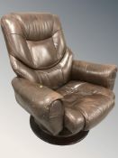 A brown stitched leather swivel armchair, width 96 cm.