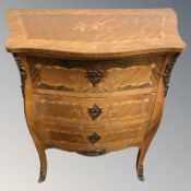 A French kingwood veneered and marquetry inlaid serpentine fronted three drawer chest,