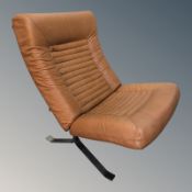 A Scandinavian stitched tan leather lounge chair.