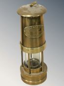 A Thomas & Williams Limited brass miner's safety lamp.