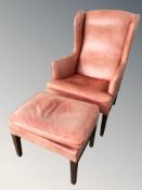 A late 20th century Danish faded leather wingback armchair and matching stool.