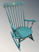 A painted and gilt spindle back rocking chair.