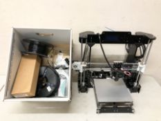 A 3D printer and box of accessories.