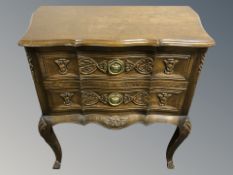 A carved beech serpentine front three drawer chest, 67 cm x 37 cm x 66 cm.