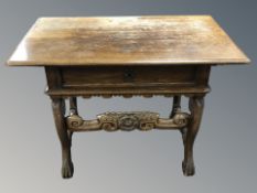 A 19th century oak side table fitted a drawer, on carved support,