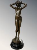 A bronze figure of a standing nude female, after Pitta Luga, on polished socle,