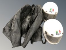 Two motorcycle helmets and leathers.