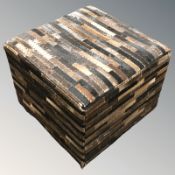 A cow hide upholstered stool,