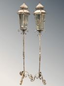 A pair of reproduction wrought metal lanterns,