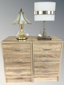 A pair of modern laminated three drawer chests, width 38 cm, and two table lamps.
