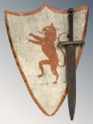 A vintage wooden sword and decorative painted shield, height 66 cm.