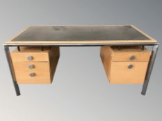 A Scandinavian metal framed oak writing desk with ebonised panel top,