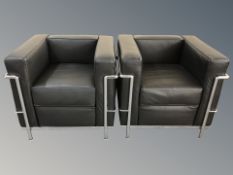 A pair of contemporary chrome and black leather armchairs, 77cm wide by 71cm deep by 68cm high.