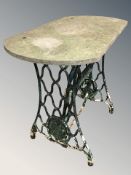 A painted cast iron Singer treadle sewing machine base, with weathered stone top,