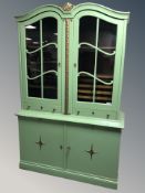 A continental painted and gilt double door bookcase, 126 cm x 48 cm x 195 cm.