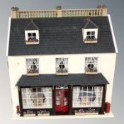A contemporary Georgian style double fronted doll's house, with well furnished interior,