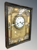 A continental wall clock in ebonised and brass surround, with enamel dial, 42 cm x 33 cm.