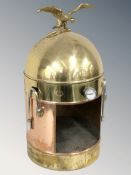 A vintage brass and copper coffee machine surmounted by an eagle, height 62 cm.