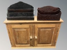 A pine double door wall cabinet, width 64 cm, and two letter racks.