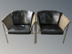 A pair of metal framed wicker and black leather armchairs,