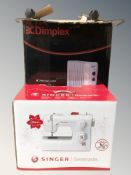 A Dimplex radiator and a Singer Serenade electric sewing machine, both in boxes.