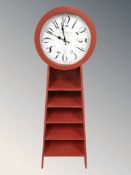 A modern shelf / CD stand incorporating a quartz clock, height 140 cm.