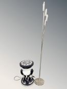 A ceramic elephant circular plant stand, height 48 cm, and a modern standard lamp.